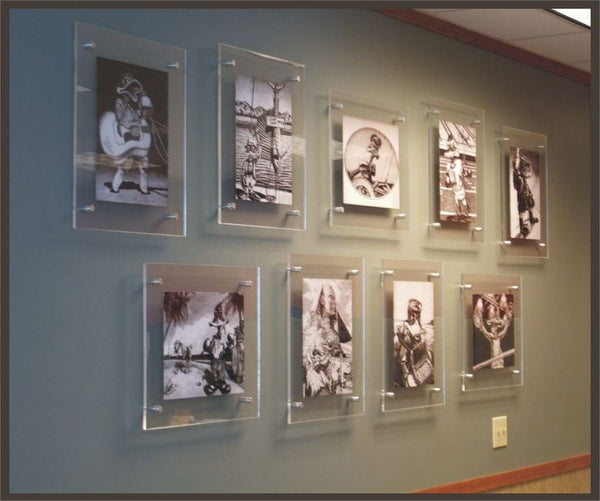 Collection of framed black and white photographs on a wall
